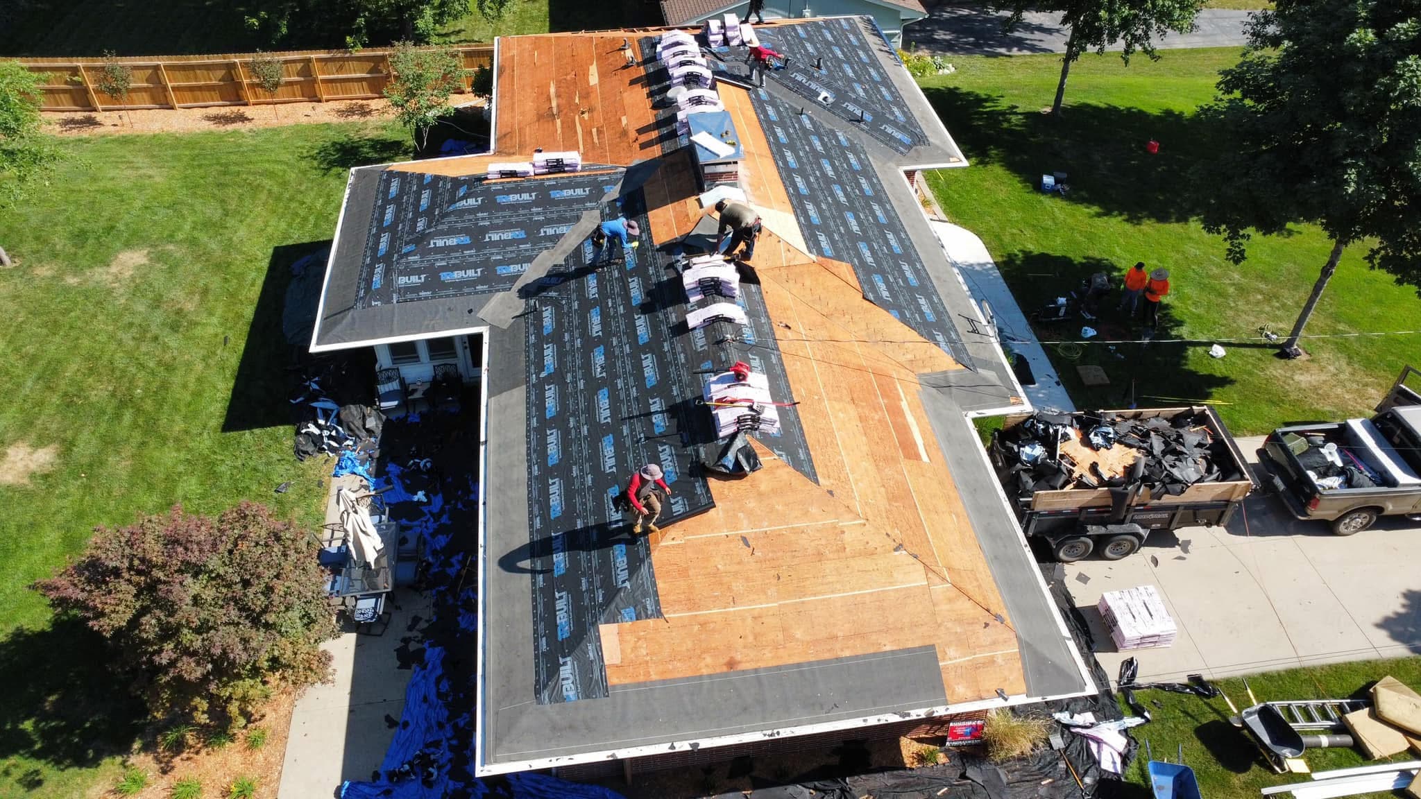 Empire Contractors crew working on a roof
